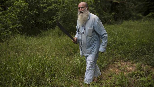 Pablo Zabala, better known as Padre Pablo, wields his machete while harvesting bananas on land owned by the Catholic Church in Boca Colorado in the Amazon. Zabala has lived in the Amazon for 24 years and spent the last 10 running a Catholic parish that works with about two dozen mining camps. (Rodrigo Abd / AP) Pablo Zabala, better known as Padre Pablo, wields his machete while harvesting bananas on land owned by the Catholic Church in Boca Colorado in the Amazon. Zabala has lived in the Amazon for 24 years and spent the last 10 running a Catholic parish that works with about two dozen mining camps. (Rodrigo Abd / AP)