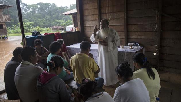 Zabala celebrates a private Mass for the Aguilar family in Boca Colorado. Many of the men and women who dig for precious metals have few other means and feel they have a more legitimate right to the Amazon’s riches than the multinational corporations also digging in. “They feel the encyclical (the Pope’s formal letter) was not created for here, but for another world,” he says. (Rodrigo Abd / AP) Zabala celebrates a private Mass for the Aguilar family in Boca Colorado. Many of the men and women who dig for precious metals have few other means and feel they have a more legitimate right to the Amazon’s riches than the multinational corporations also digging in. “They feel the encyclical (the Pope’s formal letter) was not created for here, but for another world,” he says. (Rodrigo Abd / AP)