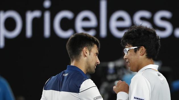 Chung Hyeon of South Korea chats with idol Novak Djokovic after beating the Serb in the pre-quarterfinals of the Australian Open tennis championships on Monday. (REUTERS)