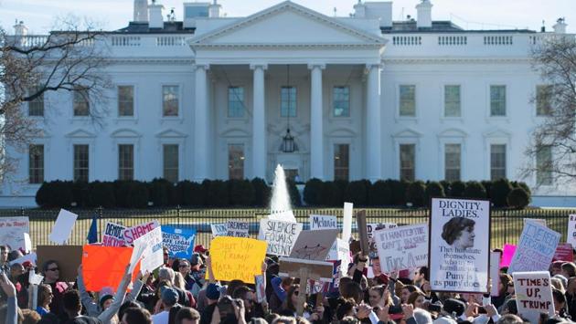 Protesters hold up a sign near the White House in Washington. Following marches that drew huge crowds across the US on Saturday, protesters gathered in multiple cities, including London, Paris, Sydney, Madrid and Buenos Aires. (Andrew Caballero-Reynolds / AFP) Protesters hold up a sign near the White House in Washington. Following marches that drew huge crowds across the US on Saturday, protesters gathered in multiple cities, including London, Paris, Sydney, Madrid and Buenos Aires. (Andrew Caballero-Reynolds / AFP)