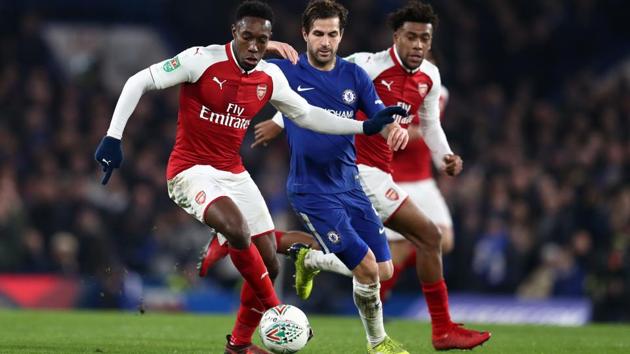 Danny Welbeck (left) of Arsenal and Cesc Fabregas of Chelsea FC (centre) vie for the ball during their League Cup semi-final first leg match at Stamford Bridge on January 10, 2018. (Getty Images) Danny Welbeck (left) of Arsenal and Cesc Fabregas of Chelsea FC (centre) vie for the ball during their League Cup semi-final first leg match at Stamford Bridge on January 10, 2018. (Getty Images)