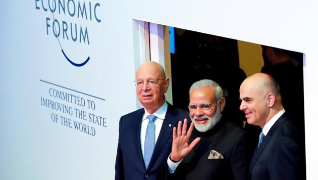 Prime Minister Narendra Modi with Klaus Schwab, Founder and Executive Chairman of World Economic Forum, and Swiss President Alain Berset as they arrive at the Opening Plenary during the World Economic Forum (WEF) annual meeting in Davos, Switzerland.(Reuters Photo)