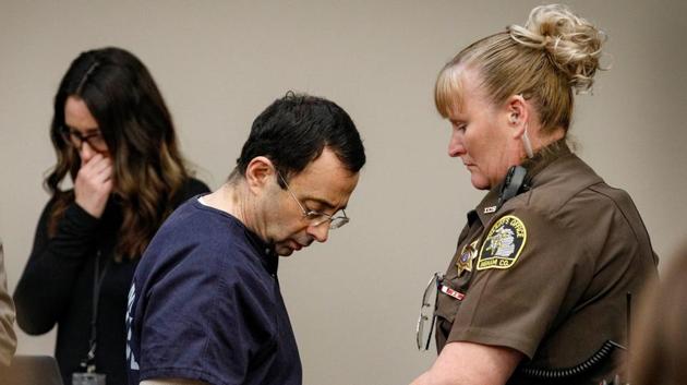 Larry Nassar, a former team USA Gymnastics doctor, who pleaded guilty in November 2017 to sexual assault charges, is handcuffed in the courtroom at the end of a day of testimony during his sentencing hearing in Lansing, Michigan.(REUTERS)