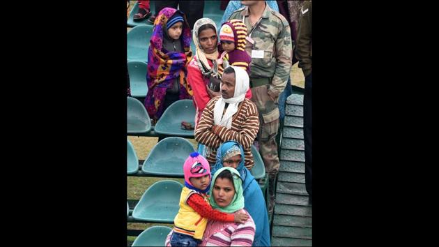 Spectators packed in warm layers were met with on-off bursts of rain that had some taking to tarp for shelter but glued nonetheless to the sights playing out. (Mohd Zakir / HT Photo) 