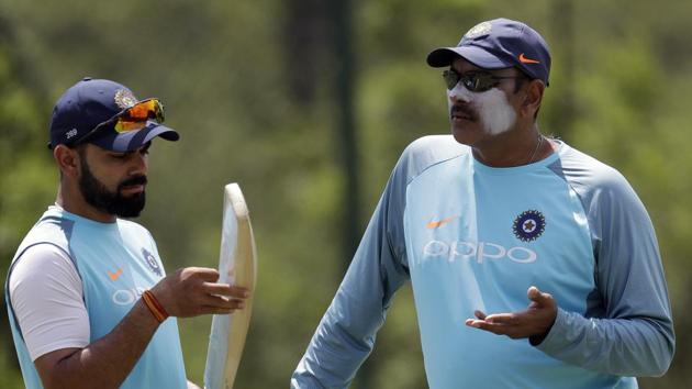 Indian cricket team captain Virat Kohli (left) chats with coach Ravi Shastri during the nets session at the Wanderers Stadium in Johannesburg, ahead of their 3rd and final Test against South Africa cricket team. (AP) Indian cricket team captain Virat Kohli (left) chats with coach Ravi Shastri during the nets session at the Wanderers Stadium in Johannesburg, ahead of their 3rd and final Test against South Africa cricket team. (AP)