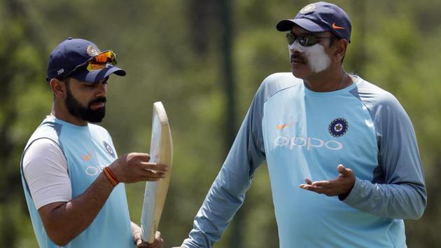 Virat Kohli, left, chats with coach Ravi Shastri ahead of India’s third Test against South Africa in Johannesburg. (AP)