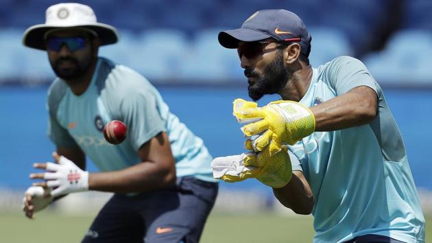 India's Dinesh Karthik, right, catches the ball as teammate Rohit Sharma looks on. (AP) India's Dinesh Karthik, right, catches the ball as teammate Rohit Sharma looks on. (AP)