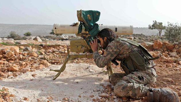 A Turkish-backed Syrian rebel fighter looks through the scope of a rocket launcher at a monitoring point near the Syrian village of Qilah, in Afrin region close to the border with Turkey.(AFP Photo) A Turkish-backed Syrian rebel fighter looks through the scope of a rocket launcher at a monitoring point near the Syrian village of Qilah, in Afrin region close to the border with Turkey.(AFP Photo)