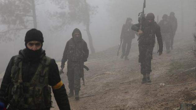 Turkish-backed Free Syrian Army fighters are seen near Mount Barsaya, northeast of Afrin, Syria. (REUTERS) Turkish-backed Free Syrian Army fighters are seen near Mount Barsaya, northeast of Afrin, Syria. (REUTERS)