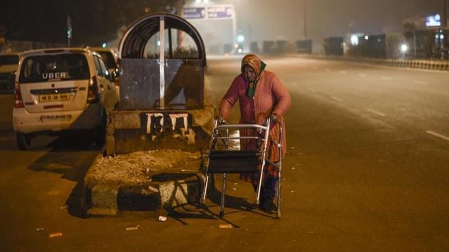 A patient uses a walker on the road outside AIIMS. The population of outstation patients who have no place to stay in order to seek treatment at the premier hospital, is growing by the day. (Burhaan Kinu / HT Photo)