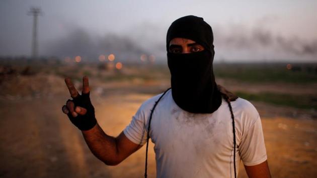 A protester gestures while posing for a photograph. “I affiliate with Jerusalem. I know one thing, the one who is blockading me in Gaza, the one who prevented me from going to pursue my dream outside Gaza is standing behind that fence,” he said. Hamas and Fatah’s rivalry has failed to achieve a lasting unity agreement and conscious of the growing influence of the youth, both have tried to court them into backing reconciliation. (Mohammed Salem / REUTERS) A protester gestures while posing for a photograph. “I affiliate with Jerusalem. I know one thing, the one who is blockading me in Gaza, the one who prevented me from going to pursue my dream outside Gaza is standing behind that fence,” he said. Hamas and Fatah’s rivalry has failed to achieve a lasting unity agreement and conscious of the growing influence of the youth, both have tried to court them into backing reconciliation. (Mohammed Salem / REUTERS)