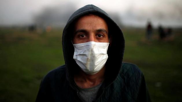 This protester wearing a medical mask said, “The world must understand that unemployment is driving us all towards becoming fighters. We are not going to fight Hamas or Fatah, we will fight the Jews only.” The daily scene on the border shows, young Palestinians are increasingly put off by a four-year stalemate in peace talks, unemployment, lack of amenities, food and little progress towards healing internal rifts. (Mohammed Salem / REUTERS) This protester wearing a medical mask said, “The world must understand that unemployment is driving us all towards becoming fighters. We are not going to fight Hamas or Fatah, we will fight the Jews only.” The daily scene on the border shows, young Palestinians are increasingly put off by a four-year stalemate in peace talks, unemployment, lack of amenities, food and little progress towards healing internal rifts. (Mohammed Salem / REUTERS)