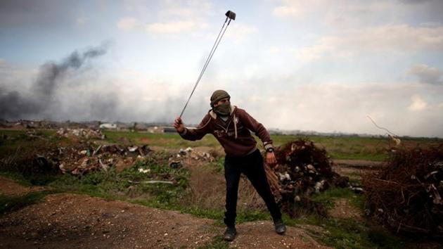 A Palestinian protester slings a stone towards Israeli forces. Slow and opaque unity efforts are another hot-button issue and underscore a common complaint by young people that party leaders do not think they count. In the absence of political dialogue within Palestinian factions or with Israel, many young Palestinians live in silence and some take to the streets. (Mohammed Salem / REUTERS) A Palestinian protester slings a stone towards Israeli forces. Slow and opaque unity efforts are another hot-button issue and underscore a common complaint by young people that party leaders do not think they count. In the absence of political dialogue within Palestinian factions or with Israel, many young Palestinians live in silence and some take to the streets. (Mohammed Salem / REUTERS)