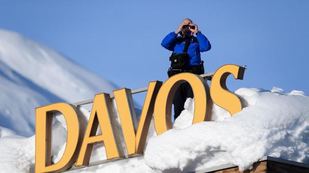 Swiss armed security personnel stand guard on the rooftop of a hotel, next to letters covered in snow reading "Davos", near the Congress Centre in Davos, eastern Switzerland. (AFP Photo) Swiss armed security personnel stand guard on the rooftop of a hotel, next to letters covered in snow reading "Davos", near the Congress Centre in Davos, eastern Switzerland. (AFP Photo)