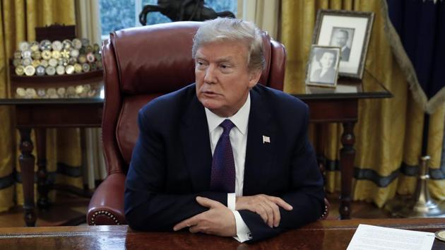 President Donald Trump sits at the Resolute Desk of the White House in Washington. (AP) President Donald Trump sits at the Resolute Desk of the White House in Washington. (AP)