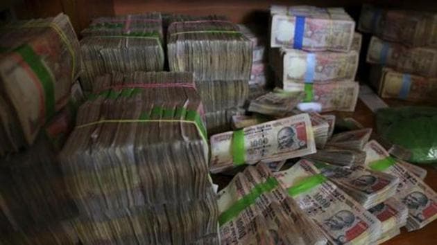 Discontinued currency notes of 1,000 denomination are seen after they were deposited by people at a bank in Bangalore, India. (AP File Photo) Discontinued currency notes of 1,000 denomination are seen after they were deposited by people at a bank in Bangalore, India. (AP File Photo)