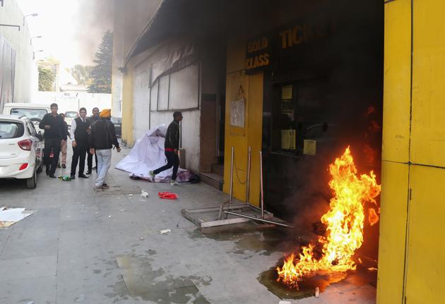 Smoke and fire emerges from a cinema ticket booth after an attack by activists in protest against the Bollywood film 'Padmaavat' in Jammu on January 24, 2018. (Alok Pathania / AFP)