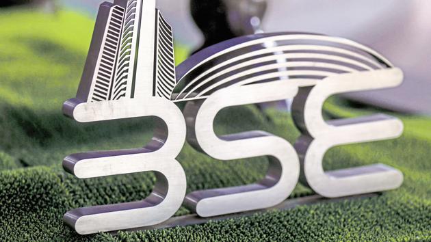 Signage for the Bombay Stock Exchange (BSE) is displayed next to a bronze bull statue at the entrance to the BSE building in Mumbai. (Bloomberg)