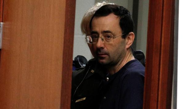Larry Nassar, a former team USA Gymnastics doctor who pleaded guilty in November 2017 to sexual assault charges, is escorted into the courtroom during his sentencing hearing in Lansing, Michigan, on Wednesday (REUTERS) Larry Nassar, a former team USA Gymnastics doctor who pleaded guilty in November 2017 to sexual assault charges, is escorted into the courtroom during his sentencing hearing in Lansing, Michigan, on Wednesday (REUTERS)