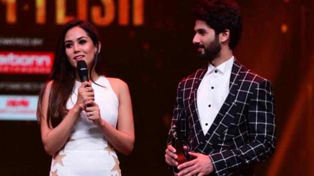Shahid Kapoor, who wore a chequered Gaurav Gupta suit, and Mira Rajput, in a body-hugging cream coloured dress, dazzled on the stage too just like the couple stood out on the red carpet. (ht photo)
