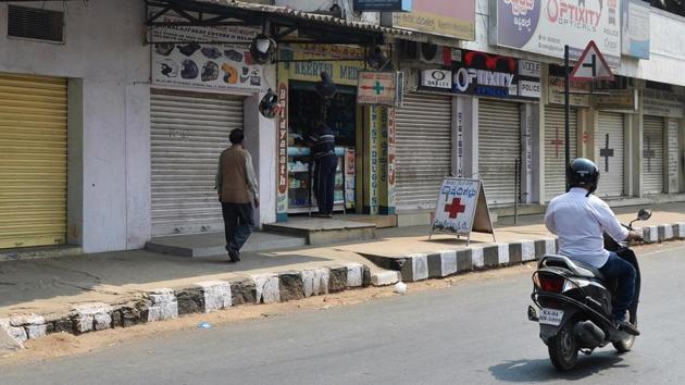 A lone pharmaceutical shop stays open, on an otherwise busy street, during a day-long Karnataka statewide general strike in Bangalore on Thursday.(AFP)