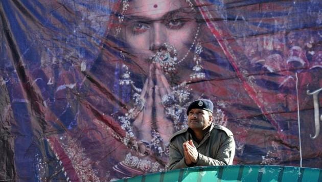 A policeman gestures at the entrance of Ritz cinema hall in Shimla on January 25. Most cinema halls in several states shelved plans to screen Sanjay Leela Bhansali’s magnum opus Padmaavat as the controversial film on legendary queen Padmini opened across the country on Thursday amid violent protests by Rajput organisations protesting alleged distortion of history. (AFP)