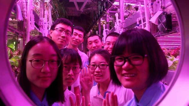 This handout picture taken and released on January 26, 2018 by the Beihang University News Centre shows Chinese students posing inside the ‘Yuegong-1’, or ‘Lunar Palace-1’ lunar lab, in Beijing. (AFP Photo) This handout picture taken and released on January 26, 2018 by the Beihang University News Centre shows Chinese students posing inside the ‘Yuegong-1’, or ‘Lunar Palace-1’ lunar lab, in Beijing. (AFP Photo)