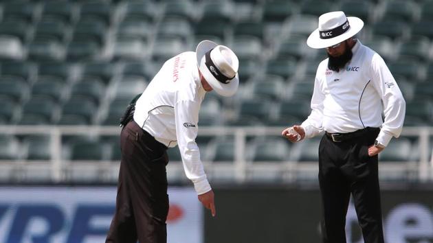 Umpires Ian Gould and Aleem Dar discuss an area on the pitch during the third day of the third Test match between South Africa and India at the Wanderers Stadium in Johannesburg. Catch highlights of India vs South Africa, 3rd Test day 3 here(BCCI)