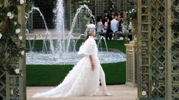 Chanel designer Karl Lagerfeld dived into the brand’s archives for his pretty-in-pink haute couture Paris show Tuesday, giving its founder Coco Chanel’s classics an intensely girly twist. Going back to nature, Chanel’s set featured architectural wooden arbors, white roses and a water fountain. (Patrick Kovarik / AFP) Chanel designer Karl Lagerfeld dived into the brand’s archives for his pretty-in-pink haute couture Paris show Tuesday, giving its founder Coco Chanel’s classics an intensely girly twist. Going back to nature, Chanel’s set featured architectural wooden arbors, white roses and a water fountain. (Patrick Kovarik / AFP)