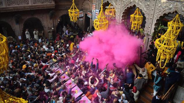 Devotees play with colours at the Banke Bihari Temple to mark the beginning of a 40-day long Holi Mahotsav in Mathura on Monday. (PTI) Devotees play with colours at the Banke Bihari Temple to mark the beginning of a 40-day long Holi Mahotsav in Mathura on Monday. (PTI)