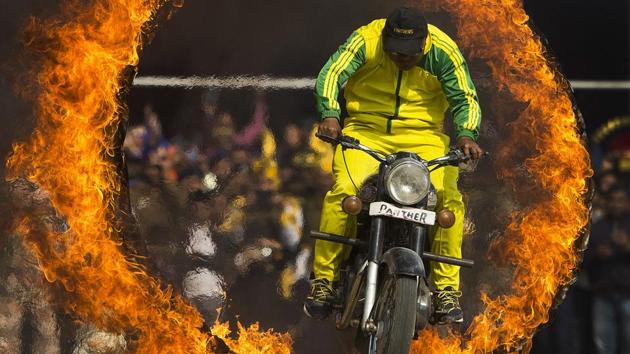 A member of Assam police jumps through a ring of fire as he performs a motorcycle stunt during celebrations in Guwahati. (Anupam Nath / AP) A member of Assam police jumps through a ring of fire as he performs a motorcycle stunt during celebrations in Guwahati. (Anupam Nath / AP)