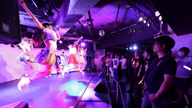 This photo taken on July 29, 2017 shows adults watching a concert by an ‘idol’ group in Tokyo. Idols, or young performers, are often sexually objectified by their adult male admirers, putting them at risk.(AFP Photo)