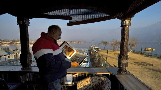 A reader leafs through a book at a store at Dal in Srinagar on Sunday. Gulshan Books, with collection of 80,000 books, was recently included in Limca Book of Records for being the only library in the country to be setup on a lake. (PTI) A reader leafs through a book at a store at Dal in Srinagar on Sunday. Gulshan Books, with collection of 80,000 books, was recently included in Limca Book of Records for being the only library in the country to be setup on a lake. (PTI)