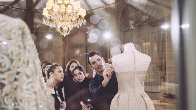 Designer Rami Al Ali is seen backstage before the Rami Al Ali presentation. Al Ali drew from baroque style with his luxuriously detailed, asymmetric hemlined gowns in this year’s spring/summer collection. (Gareth Cattermole / Getty Images) Designer Rami Al Ali is seen backstage before the Rami Al Ali presentation. Al Ali drew from baroque style with his luxuriously detailed, asymmetric hemlined gowns in this year’s spring/summer collection. (Gareth Cattermole / Getty Images)