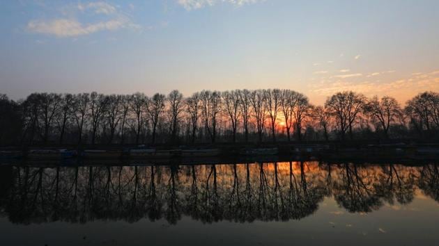 Silhouetted house boats and chinar trees are reflected on the waters of Dal lake in Srinagar on Wednesday. (Waseem Andrani / HT Photo) Silhouetted house boats and chinar trees are reflected on the waters of Dal lake in Srinagar on Wednesday. (Waseem Andrani / HT Photo)