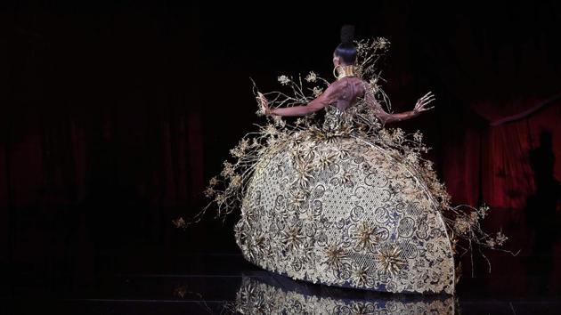 Guo Pei, the designer behind Rihanna’s 2015 Met Ball outfit put out confections in blue and gold. All handcrafted, from shoulder embellishments to flocks of golden flowers flying out of domed gowns. (Patrick Kovarik / AFP) Guo Pei, the designer behind Rihanna’s 2015 Met Ball outfit put out confections in blue and gold. All handcrafted, from shoulder embellishments to flocks of golden flowers flying out of domed gowns. (Patrick Kovarik / AFP)