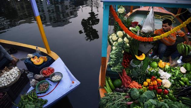 A shopkeeper waits for customers in a boat after the opening of the floating market in Kolkata on Wednesday. A market modelled on a floating market in the Thai capital Bangkok has opened in Kolkata, employing over 200 stall owners affected by the widening of the Eastern Metropolitan Bypass. (Dibyangshu Sarkar / AFP) A shopkeeper waits for customers in a boat after the opening of the floating market in Kolkata on Wednesday. A market modelled on a floating market in the Thai capital Bangkok has opened in Kolkata, employing over 200 stall owners affected by the widening of the Eastern Metropolitan Bypass. (Dibyangshu Sarkar / AFP)