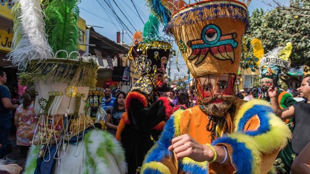"Chinelos" traditional dancers perform during the carnival celebrations in Jiutepec, Mexico on January 23, 2018. The "Chinelos" tradition is one of the many developed after the conquest when native and catholic rites blended, these dancers represent in a satirical way the Europeans' -who banned peasants to attend carnival festivities- and their fancy style. (Omar Torres / AFP) "Chinelos" traditional dancers perform during the carnival celebrations in Jiutepec, Mexico on January 23, 2018. The "Chinelos" tradition is one of the many developed after the conquest when native and catholic rites blended, these dancers represent in a satirical way the Europeans' -who banned peasants to attend carnival festivities- and their fancy style. (Omar Torres / AFP)