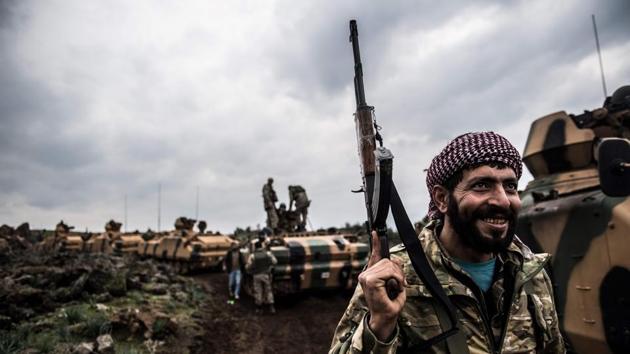 Turkish army tanks and soldiers gather close to the Syrian border on January 21, 2018 at Hassa in Hatay province. Turkish forces on January 20, 2018, began a major new operation aimed at ousting the Peoples’ Protection Units (YPG) Kurdish militia from Afrin, pounding dozens of targets from the sky in air raids and with artillery. (Bulent Kilic / AFP) Turkish army tanks and soldiers gather close to the Syrian border on January 21, 2018 at Hassa in Hatay province. Turkish forces on January 20, 2018, began a major new operation aimed at ousting the Peoples’ Protection Units (YPG) Kurdish militia from Afrin, pounding dozens of targets from the sky in air raids and with artillery. (Bulent Kilic / AFP)