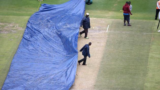 Ground staff bring the covers on before the start of the fourth day. The day started almost one hour late. (BCCI) 