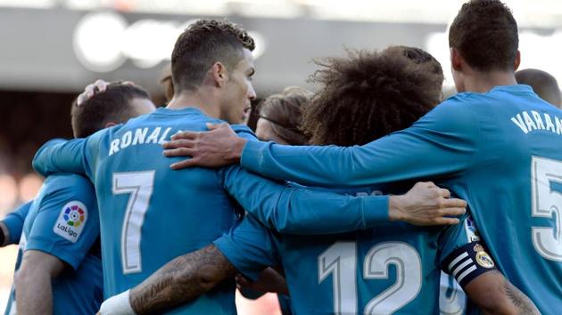Real Madrid's Cristiano Ronaldo (2nd left) celebrates with teammates after shooting a penalty kick during the Spanish La Liga match against Valencia at the Mestalla stadium on Saturday.(AFP) Real Madrid's Cristiano Ronaldo (2nd left) celebrates with teammates after shooting a penalty kick during the Spanish La Liga match against Valencia at the Mestalla stadium on Saturday.(AFP)