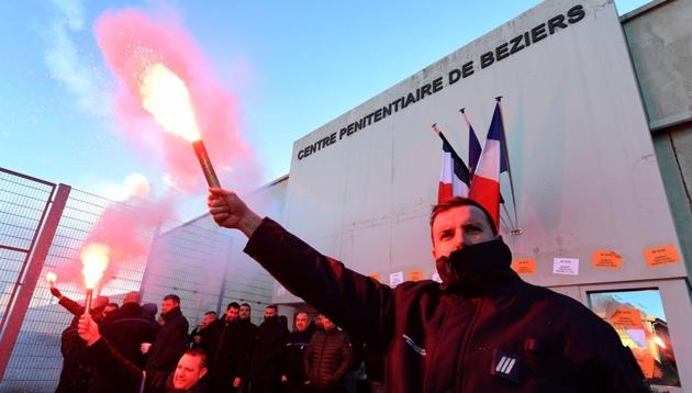 Striking prison guards brandish smoke bombs as they demonstrate outside the Beziers prison on January 23, 2018 as part of a nationwide movement to call for better safety and wages. (AFP) Striking prison guards brandish smoke bombs as they demonstrate outside the Beziers prison on January 23, 2018 as part of a nationwide movement to call for better safety and wages. (AFP)