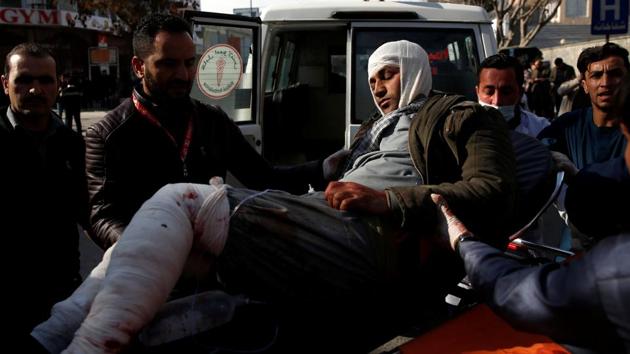 An injured man is carried to the hospital after the blast in Kabul. Mirwais Yasini, a member of parliament who was nearby when the explosion occurred, said an ambulance approached the checkpoint and blew up. The target was apparently an interior ministry building nearby. (Mohammad Ismail / REUTERS)