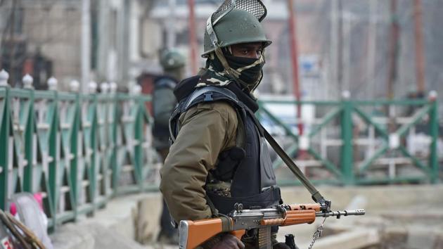 An Indian paramilitary trooper stands guard on the eve of Republic Day in Srinagar.(AFP FILE)