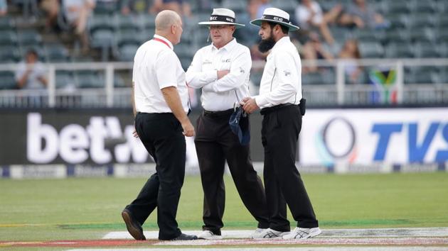 Umpires Ian Gould (C), Aleem Dar (R) and referee Andy Pycroft had a lengthy discussion on continuing the 3rd Test between India and South Africa.(AFP) Umpires Ian Gould (C), Aleem Dar (R) and referee Andy Pycroft had a lengthy discussion on continuing the 3rd Test between India and South Africa.(AFP)
