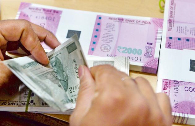 A bank staff member counts notes to give to customers 2016, in the wake of the demonetisation of old 500 and 1000 rupee notes in Mumbai. The Indian economy, which will end March as a $2.6 trillion dollar one, is back where it was ahead of demonetisation. (AFP) A bank staff member counts notes to give to customers 2016, in the wake of the demonetisation of old 500 and 1000 rupee notes in Mumbai. The Indian economy, which will end March as a $2.6 trillion dollar one, is back where it was ahead of demonetisation. (AFP)