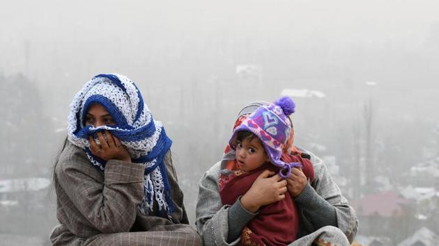 A Kashmiri family sits on the top of the hill in the outskirts of Srinagar on November 29, 2017.(AFP) A Kashmiri family sits on the top of the hill in the outskirts of Srinagar on November 29, 2017.(AFP)