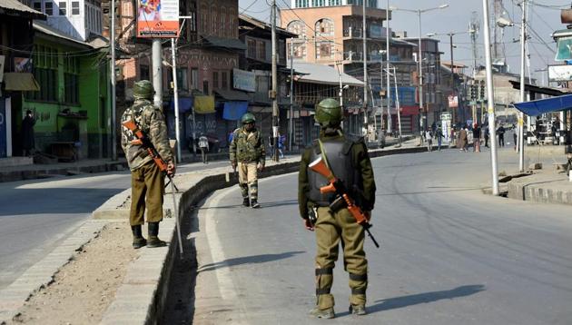 Security personnel patrol a street during restrictions in Srinagar on Sunday, in view of a strike called by separatists to protest the killing of two youth in Shopian district. (PTI) Security personnel patrol a street during restrictions in Srinagar on Sunday, in view of a strike called by separatists to protest the killing of two youth in Shopian district. (PTI)