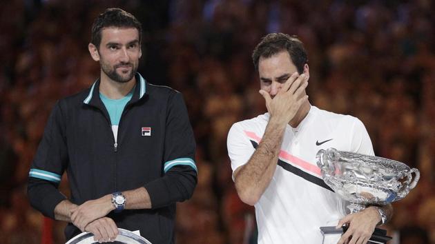 Roger Federer, right, wipes tears from his eyes after defeating Marin Cilic, left, in the men's singles final at the Australian Open. (AP) Roger Federer, right, wipes tears from his eyes after defeating Marin Cilic, left, in the men's singles final at the Australian Open. (AP)