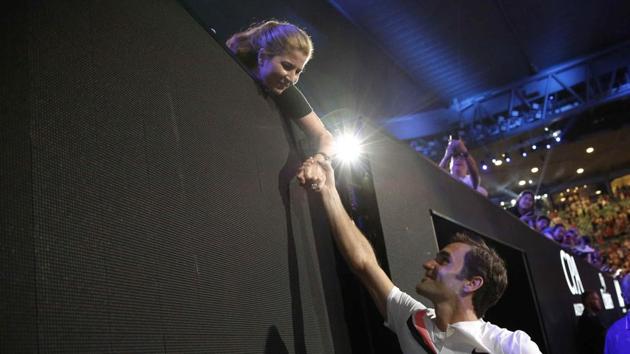 Roger Federer shakes hands with his wife Mirka while holding the Australian Open trophy. (REUTERS)